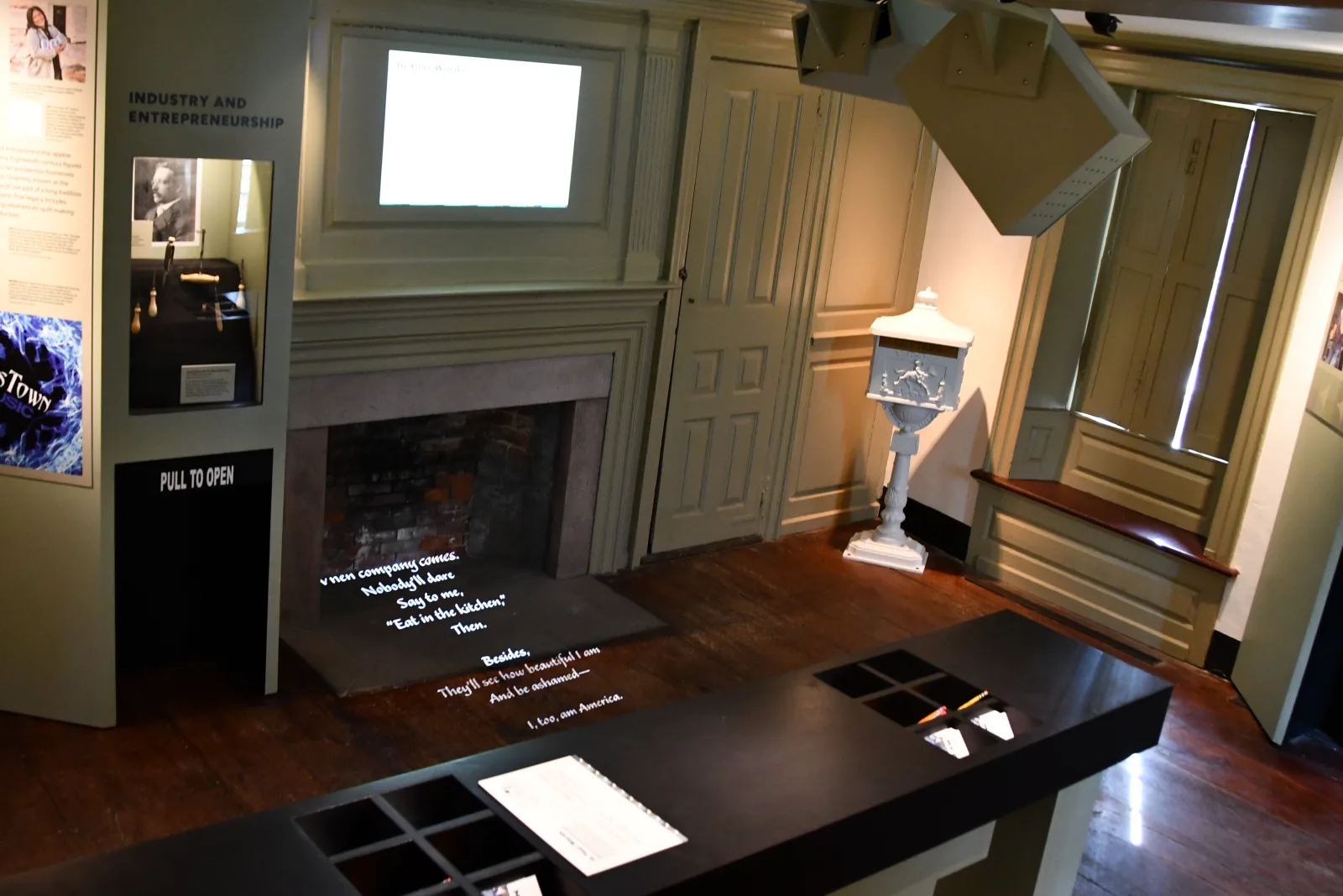 Custom gobo projection casting poetry across the hearth of the Wanton-Lyman-Hazard House exhibit room