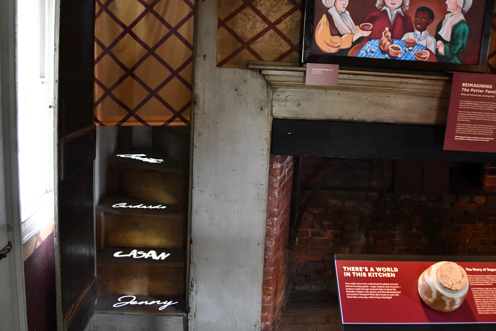 Names of enslaved residents projected onto the original staircase of the Wanton-Lyman-Hazard House